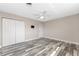 Bedroom featuring weathered wood flooring, closet, ceiling fan and mount for TV at 1313 Buereau Rd, Englewood, FL 34223