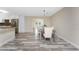 Dining area with hardwood floors open to the kitchen and access to the back porch at 1313 Buereau Rd, Englewood, FL 34223