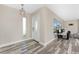 Welcoming foyer featuring plank flooring, stylish light fixture, and a view into the living area at 1313 Buereau Rd, Englewood, FL 34223