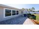 Inviting front porch with brick paving, decorative plants, and a stylish front door and accent windows at 1313 Buereau Rd, Englewood, FL 34223