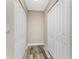 Hallway with white double closets and wood-look flooring at 1313 Buereau Rd, Englewood, FL 34223