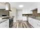 Bright kitchen featuring white cabinets, stainless steel appliances, granite countertops, and decorative backsplash at 1313 Buereau Rd, Englewood, FL 34223