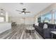 Spacious living room featuring hardwood floors, ceiling fan, and a seamless flow to the dining area at 1313 Buereau Rd, Englewood, FL 34223