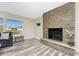 Bright living room featuring a stone fireplace, hardwood floors and lots of natural light at 1313 Buereau Rd, Englewood, FL 34223