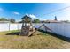 Backyard play structure for with a slide and climbing wall and swing at 1313 Buereau Rd, Englewood, FL 34223