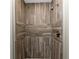 Shower enclosure featuring wood-look tiling and bronze fixtures at 1313 Buereau Rd, Englewood, FL 34223