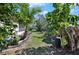 Long backyard featuring trees, a grassy path, and a storage shed at 1320 Bayshore Dr, Englewood, FL 34223