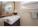 Bathroom vanity with unique vessel sink, modern fixtures, large mirror and neutral wall color at 1320 Bayshore Dr, Englewood, FL 34223