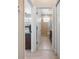 Hallway view into bathroom featuring a tile shower and vanity at 1320 Bayshore Dr, Englewood, FL 34223