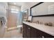 Bathroom featuring a tile shower, large mirror, and vanity with marble countertop at 1320 Bayshore Dr, Englewood, FL 34223