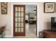 View through french doors into a bedroom with a four-poster bed and neutral decor at 1320 Bayshore Dr, Englewood, FL 34223