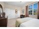 Bedroom with walk-in closet, laminate flooring, and window with view at 1320 Bayshore Dr, Englewood, FL 34223