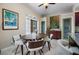 Dining room featuring a wooden table, six chairs, and art on the walls, adjacent to the kitchen at 1320 Bayshore Dr, Englewood, FL 34223