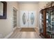 Entryway featuring light floors and a decorative glass double door at 1320 Bayshore Dr, Englewood, FL 34223