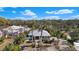 Charming home with a metal roof, blue shutters, and lush tropical landscaping, creating a serene and inviting atmosphere at 1320 Bayshore Dr, Englewood, FL 34223