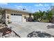 View of the home's white garage door and the concrete driveway leading up to the house at 1320 Bayshore Dr, Englewood, FL 34223