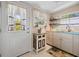 Galley kitchen showcases ample storage and a window over the sink providing lots of natural light at 1320 Bayshore Dr, Englewood, FL 34223