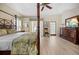 Comfortable main bedroom featuring a four poster bed, neutral walls, and bright natural light at 1320 Bayshore Dr, Englewood, FL 34223