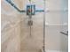 Close up of tiled shower with shower head and art insert at 1320 Bayshore Dr, Englewood, FL 34223