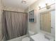 Bathroom featuring a shower with gray and white tiles, single vanity, and matching medicine cabinet at 18970 Mcgrath Cir, Port Charlotte, FL 33948