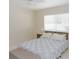 Bedroom with a patterned comforter, wooden bed frame, and natural light from the window at 18970 Mcgrath Cir, Port Charlotte, FL 33948