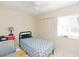 Bedroom with a patterned comforter, wooden bed frame, and natural light from the window at 18970 Mcgrath Cir, Port Charlotte, FL 33948