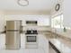 Well-lit kitchen featuring stainless steel appliances, ample cabinet space, and a functional layout at 18970 Mcgrath Cir, Port Charlotte, FL 33948