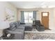 Cozy living room with comfortable gray sectional, recliner, area rug, and door to the exterior at 18970 Mcgrath Cir, Port Charlotte, FL 33948