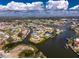 An aerial view showcases a waterfront home with canal access amid a residential neighborhood at 1918 Greenlawn Dr, Englewood, FL 34223