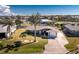 Aerial view of a well-maintained home featuring mature trees, long driveway, and lush green lawn at 1918 Greenlawn Dr, Englewood, FL 34223