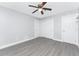 This bedroom features wood-look flooring, neutral paint, a closet, and a ceiling fan at 1918 Greenlawn Dr, Englewood, FL 34223