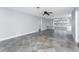 Living room featuring neutral paint, ceiling fan, tiled floor, and built-in shelving at 1918 Greenlawn Dr, Englewood, FL 34223