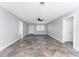 Spacious living room with tiled floor, neutral paint, ceiling fan, and natural light at 1918 Greenlawn Dr, Englewood, FL 34223