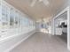 Bright sunroom features tile flooring, wooden ceiling, and windows with plantation shutters at 1918 Greenlawn Dr, Englewood, FL 34223