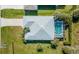 Aerial view of a home with a screened pool and meticulously maintained grounds at 194 Sunset Rd, Rotonda West, FL 33947