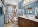 Nautical themed bathroom with blue walls, tile shower and vanity with decorative accents at 194 Sunset Rd, Rotonda West, FL 33947