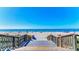 Wooden walkway leading to a sandy beach, inviting relaxation by the ocean at 194 Sunset Rd, Rotonda West, FL 33947