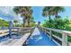 Inviting boardwalk leading to the beach, lined with palm trees and lush greenery at 194 Sunset Rd, Rotonda West, FL 33947