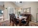 Inviting dining room with a large window, elegant table setting, and decorative mirror at 194 Sunset Rd, Rotonda West, FL 33947