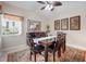 Dining room with large window, mirror, and tropical wall art at 194 Sunset Rd, Rotonda West, FL 33947