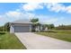 Beautiful home featuring a spacious driveway, attached garage, and well-kept lawn at 194 Sunset Rd, Rotonda West, FL 33947