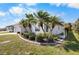 Charming single-story home featuring lush landscaping and well-manicured lawn at 194 Sunset Rd, Rotonda West, FL 33947