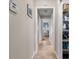 Hallway with neutral walls and tile flooring, includes a storage closet and glimpses of the primary bedroom at 194 Sunset Rd, Rotonda West, FL 33947