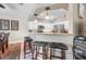 Bright kitchen featuring white cabinetry, stainless steel appliances and a breakfast bar with seating at 194 Sunset Rd, Rotonda West, FL 33947