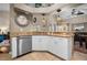 Modern kitchen with stainless steel dishwasher, granite countertops, and white cabinetry at 194 Sunset Rd, Rotonda West, FL 33947