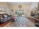 Spacious living room featuring sliding glass doors to the patio and hardwood floors at 194 Sunset Rd, Rotonda West, FL 33947