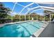 Screened in pool with outdoor seating at 194 Sunset Rd, Rotonda West, FL 33947