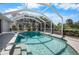 A screened pool sparkles with an inviting entry step and convenient safety railing at 194 Sunset Rd, Rotonda West, FL 33947