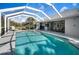 A screened pool with an expansive patio area invites outdoor enjoyment and relaxation at 194 Sunset Rd, Rotonda West, FL 33947