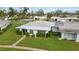 Aerial view of a lovely one story home with mature landscaping in a peaceful neighborhood with green lawns at 3220 Southfield Ln # 810, Sarasota, FL 34239